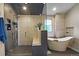 Elegant bathroom with glass shower, soaking tub, patterned tile, and sleek fixtures at 1750 E Noble Pl, Centennial, CO 80121