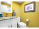Stylish half bathroom with granite countertop, modern fixtures, and vibrant yellow walls for a cheerful ambiance at 1750 E Noble Pl, Centennial, CO 80121