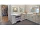 Bright bathroom with dual lighted mirrors over a spacious vanity and lots of storage at 1750 E Noble Pl, Centennial, CO 80121