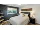 Serene bedroom with a queen bed, tasteful decor, and a large window providing ample natural light at 1750 E Noble Pl, Centennial, CO 80121