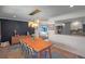 Elegant dining room featuring a modern chandelier, designer accent wall, and views into the kitchen at 1750 E Noble Pl, Centennial, CO 80121
