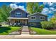 Charming two-story home with gray siding, brick accents, wood shutters, and a beautifully landscaped front yard at 1750 E Noble Pl, Centennial, CO 80121