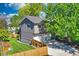 Home exterior with a three-car garage, fenced yard, and mature trees providing shade at 1750 E Noble Pl, Centennial, CO 80121