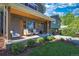 Inviting front porch with cozy seating and wood accents, perfect for relaxing outdoors and enjoying the landscaped yard at 1750 E Noble Pl, Centennial, CO 80121