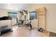 Well-equipped home gym with fitness machines and natural light, creating a perfect space for workouts at 1750 E Noble Pl, Centennial, CO 80121