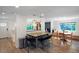 Open-concept kitchen with bar seating, modern lighting, and seamless transition to the dining area and entryway at 1750 E Noble Pl, Centennial, CO 80121