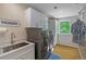 Efficient laundry room with modern washer, dryer, ample storage, and a practical layout at 1750 E Noble Pl, Centennial, CO 80121