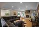 Inviting living room with a stone fireplace, large sectional sofa, and an open layout to the kitchen area at 1750 E Noble Pl, Centennial, CO 80121