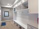 Bright mudroom with built-in storage, coat hooks, bench seating, and durable flooring at 1750 E Noble Pl, Centennial, CO 80121