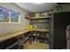 Organized storage room featuring built-in shelving, a workbench, and ample space for storing tools and supplies at 1750 E Noble Pl, Centennial, CO 80121