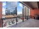 Balcony overlooking a city skyline and adjacent buildings at 1800 Lawrence St # 303, Denver, CO 80202