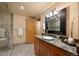 Bathroom with a granite countertop vanity, glass bowl sink, and modern fixtures at 1800 Lawrence St # 303, Denver, CO 80202