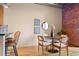 Cozy dining area with stylish decor, exposed brick wall, and natural light at 1800 Lawrence St # 303, Denver, CO 80202