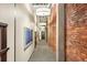 Hallway with brick accent wall, featuring artwork, carpeted floors and recessed lighting at 1800 Lawrence St # 303, Denver, CO 80202