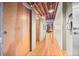 Hallway with hardwood floors and exposed ceiling beams at 1800 Lawrence St # 303, Denver, CO 80202