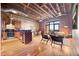 Spacious living area featuring exposed brick, hardwood floors, and an open floor plan at 1800 Lawrence St # 303, Denver, CO 80202