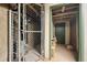 Storage area with chain-link fencing and a green door at 1800 Lawrence St # 303, Denver, CO 80202