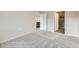 Bedroom featuring neutral carpet, white doors, and access to closet and kitchen at 844 W 128Th Pl, Westminster, CO 80234