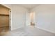 A bright bedroom with neutral carpet features a walk-in closet and a secondary door to another room at 844 W 128Th Pl, Westminster, CO 80234
