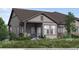 Inviting home with a covered front porch, complemented by stone accents and beautiful green landscaping at 844 W 128Th Pl, Westminster, CO 80234