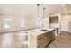 Open-concept kitchen with an island, undermount sink, and stainless steel dishwasher at 844 W 128Th Pl, Westminster, CO 80234