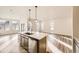 Spacious kitchen island featuring a dishwasher and undermount sink, open to living area at 844 W 128Th Pl, Westminster, CO 80234