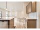 Bright kitchen with white countertops, wood cabinets, and a view to the open living space at 844 W 128Th Pl, Westminster, CO 80234