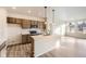 Well-lit kitchen featuring a center island, modern appliances, and sleek wood cabinets at 844 W 128Th Pl, Westminster, CO 80234