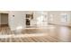 Bright, open living area with wood floors, flows to the modern kitchen, and large windows fill the space at 844 W 128Th Pl, Westminster, CO 80234