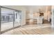 Open-concept living space with wood floors, sliding glass doors to the patio and kitchen with island at 844 W 128Th Pl, Westminster, CO 80234