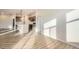 Spacious living area with wood floors, flowing into the kitchen area and modern pendant lighting at 844 W 128Th Pl, Westminster, CO 80234