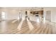 Open-concept living area with wood floors, seamlessly connects to the kitchen, great natural light and airy space at 844 W 128Th Pl, Westminster, CO 80234