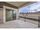 Covered patio with black metal railing and views of the lawn at 844 W 128Th Pl, Westminster, CO 80234