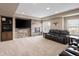 Finished basement with stone fireplace, large TV, and comfortable seating area at 13507 W 87Th Ter, Arvada, CO 80005