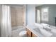 This bathroom features a shower/tub combination with a white shower curtain and single vanity at 13507 W 87Th Ter, Arvada, CO 80005