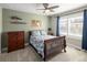 A bedroom with natural light features a ceiling fan and dresser with shelves at 13507 W 87Th Ter, Arvada, CO 80005