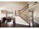 Bright entryway with dark wood floors, staircase with iron spindles, and dining area view at 13507 W 87Th Ter, Arvada, CO 80005