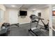 Home gym features exercise equipment, television, and rubber flooring at 13507 W 87Th Ter, Arvada, CO 80005