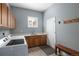 Spacious laundry room with washer, dryer, wooden cabinets, and convenient sink at 13507 W 87Th Ter, Arvada, CO 80005