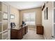 Well-lit home office with a large wooden desk and comfortable executive chair at 13507 W 87Th Ter, Arvada, CO 80005