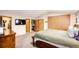 Bedroom with a walk-in closet, tv, ensuite bathroom, closet, and access to the stairs at 19709 Rosewood Ct, Parker, CO 80138
