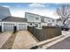 Exterior view of the townhouse featuring a wooden fence, a two car garage, and a patio at 19709 Rosewood Ct, Parker, CO 80138