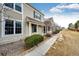 A beautiful townhome with great curb appeal featuring a sidewalk and landscaped lawn at 19709 Rosewood Ct, Parker, CO 80138