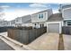 View of the back of the townhouse with a wooden fence and a two car garage at 19709 Rosewood Ct, Parker, CO 80138