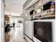 Bright laundry room featuring modern appliances, shelving, and easy access to the kitchen area at 19709 Rosewood Ct, Parker, CO 80138