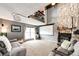 Cozy living room with a stone fireplace, comfortable seating, and a soaring ceiling at 19709 Rosewood Ct, Parker, CO 80138