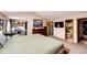 Spacious primary bedroom with an ensuite bathroom, office space, and closet at 19709 Rosewood Ct, Parker, CO 80138