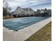Community pool with a secure cover in front of condos on a sunny day at 19709 Rosewood Ct, Parker, CO 80138