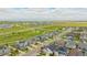 Wide aerial view of the community with green spaces, walking paths, and homes with solar panels at 91 S Quantock St, Aurora, CO 80018