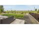 Large grass backyard with wood fence offering privacy, outdoor seating, and distant community view at 91 S Quantock St, Aurora, CO 80018